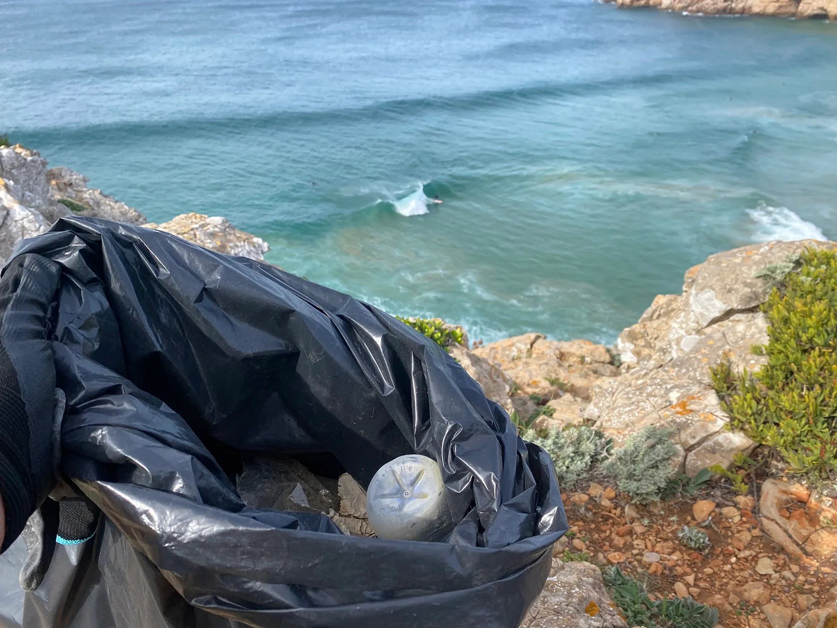 A close up of rubbish picked up in a trash bag near the coast